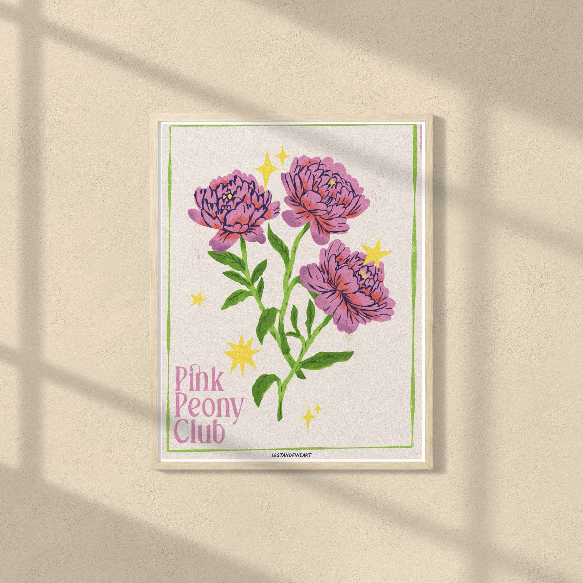 Framed artwork of pink peonies with 'Pink Peony Club' text on a beige wall.