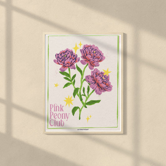 Framed artwork of pink peonies with 'Pink Peony Club' text on a beige wall.