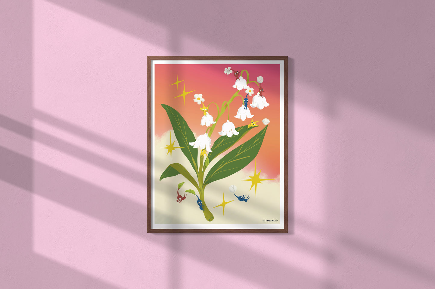 Framed artwork of a floral design on a pink wall